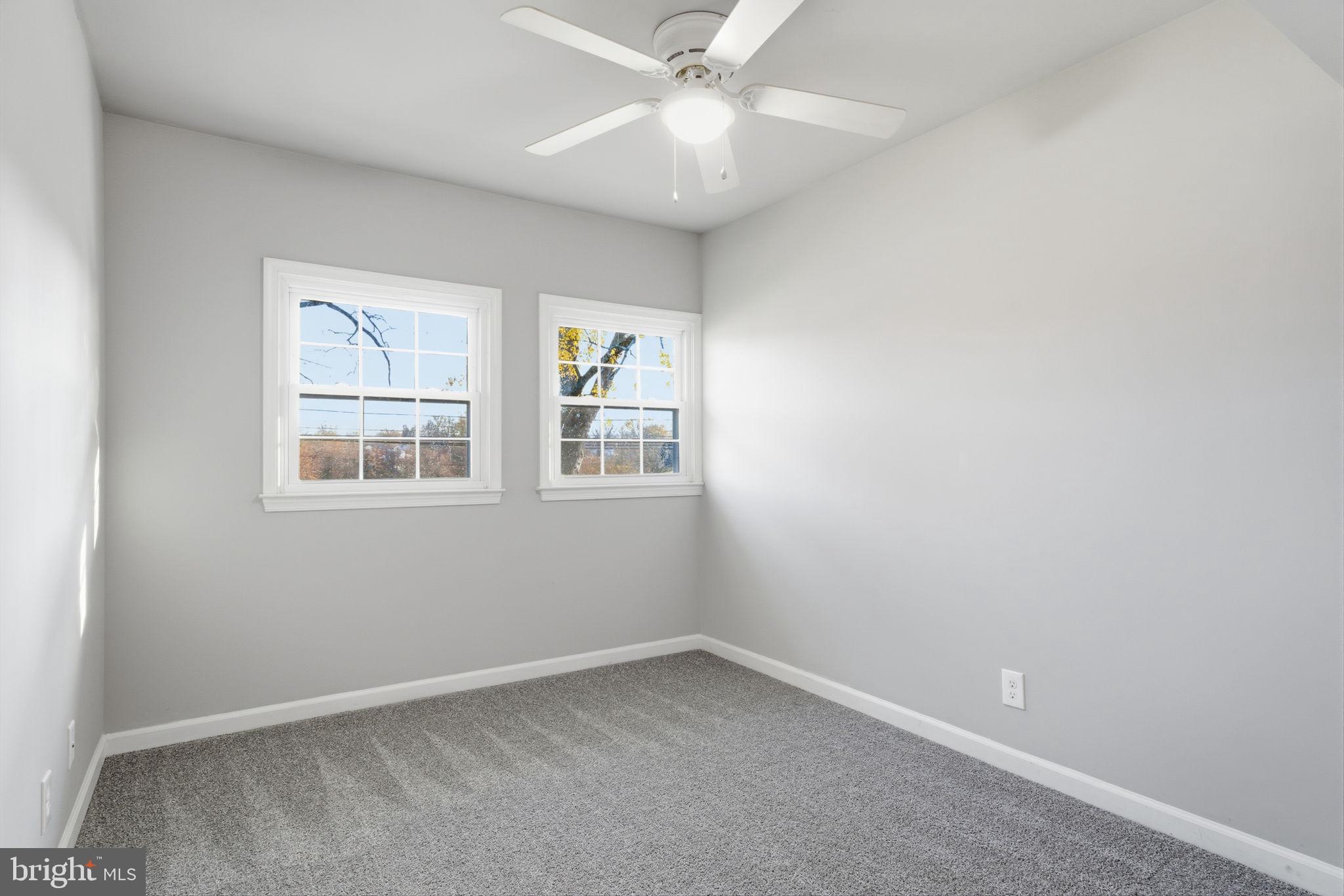 208 Trenton Road Fairless Hills, PA 19030 - Photo 27 of 35 an empty room with windows and ceiling fan