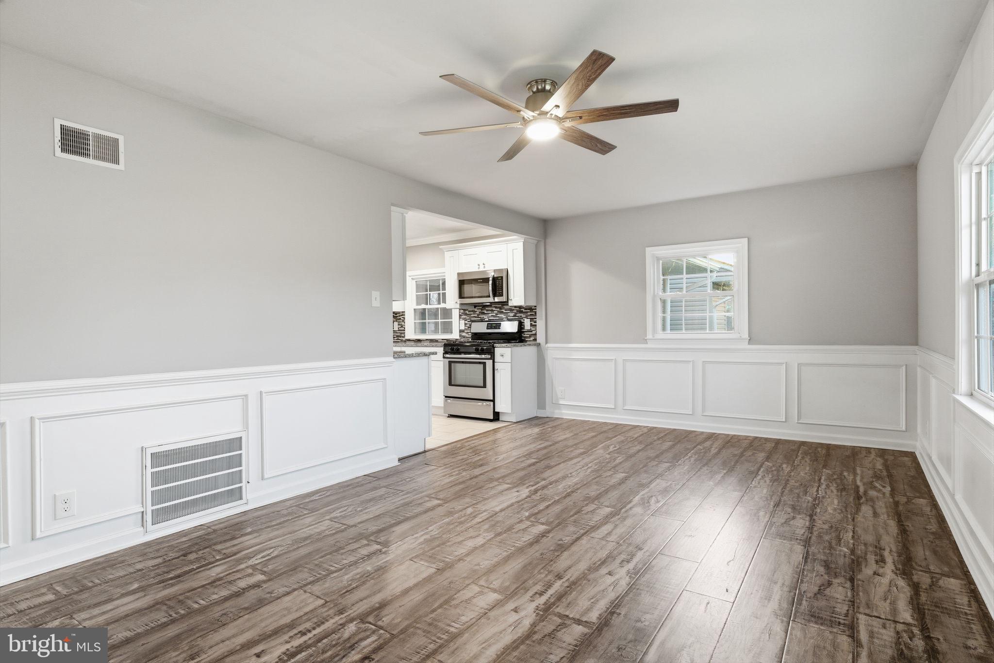 208 Trenton Road Fairless Hills, PA 19030 - Photo 8 of 35 a view of a kitchen with wooden floor electronic appliances and windows