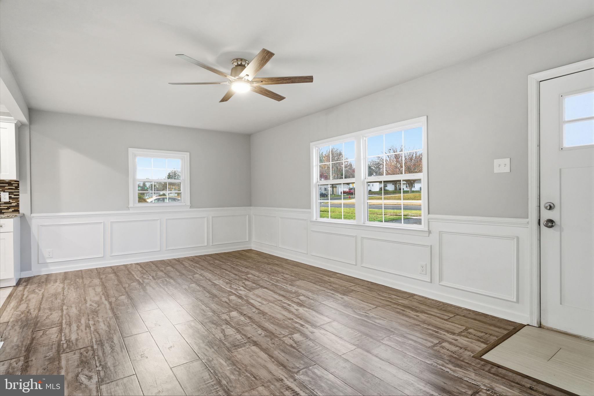 208 Trenton Road Fairless Hills, PA 19030 - Photo 9 of 35 a view of an empty room with a window and wooden floor