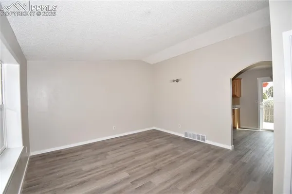 a view of a room with wooden floor