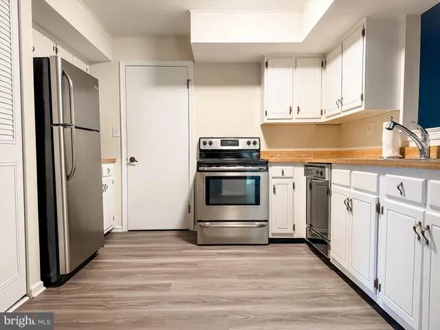 a kitchen with a refrigerator and a sink