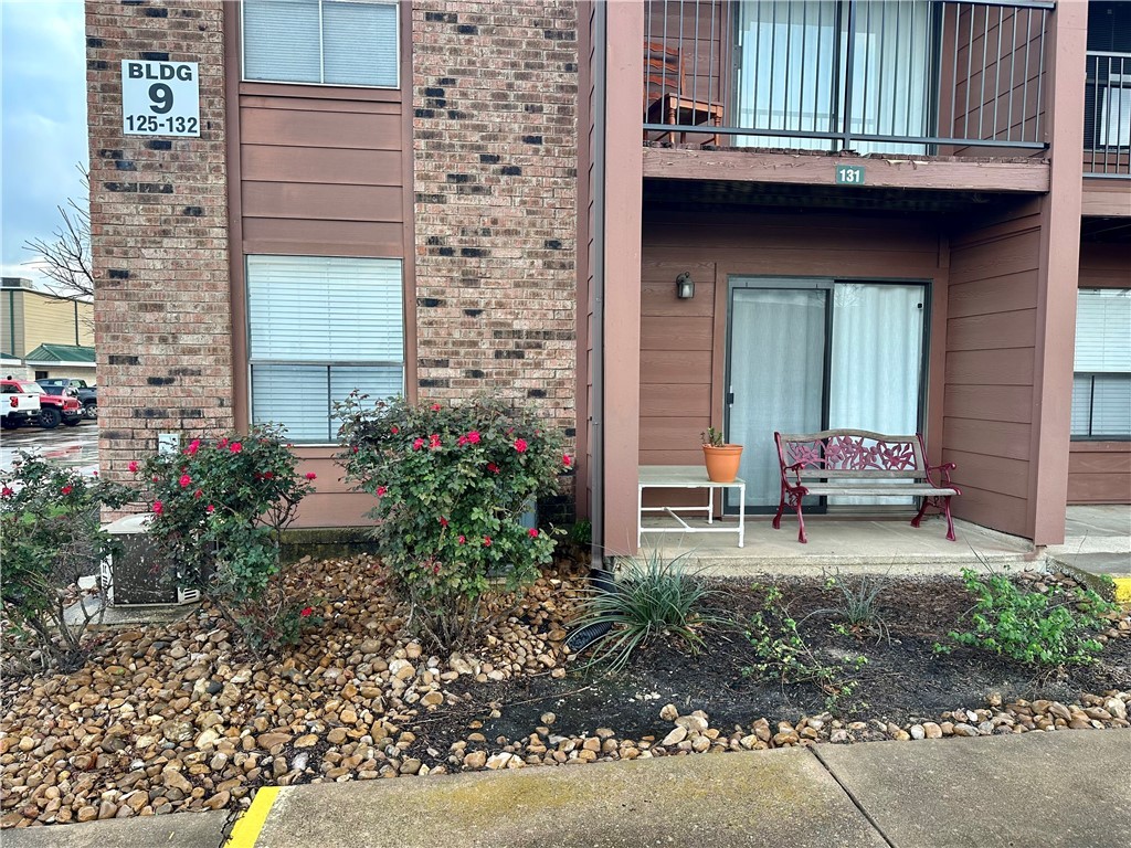 904 University Oaks Boulevard, Unit 131 College Station, TX 77840 - Photo 1 of 17 Property entrance with brick siding and a patio