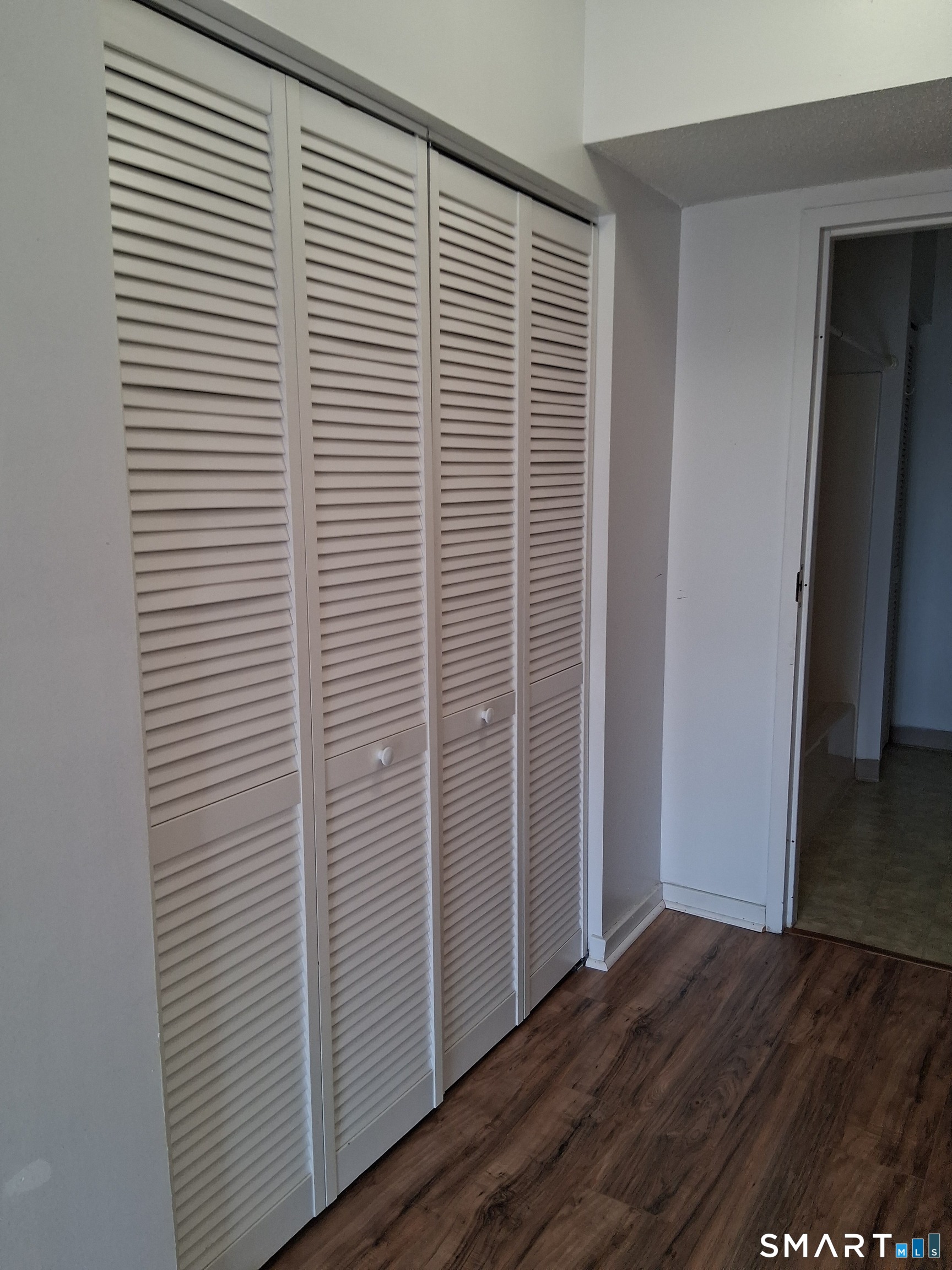 75 Washington Avenue, Unit 2402 Hamden, CT 06518 - Photo 8 of 11 a view of a room with wooden floor