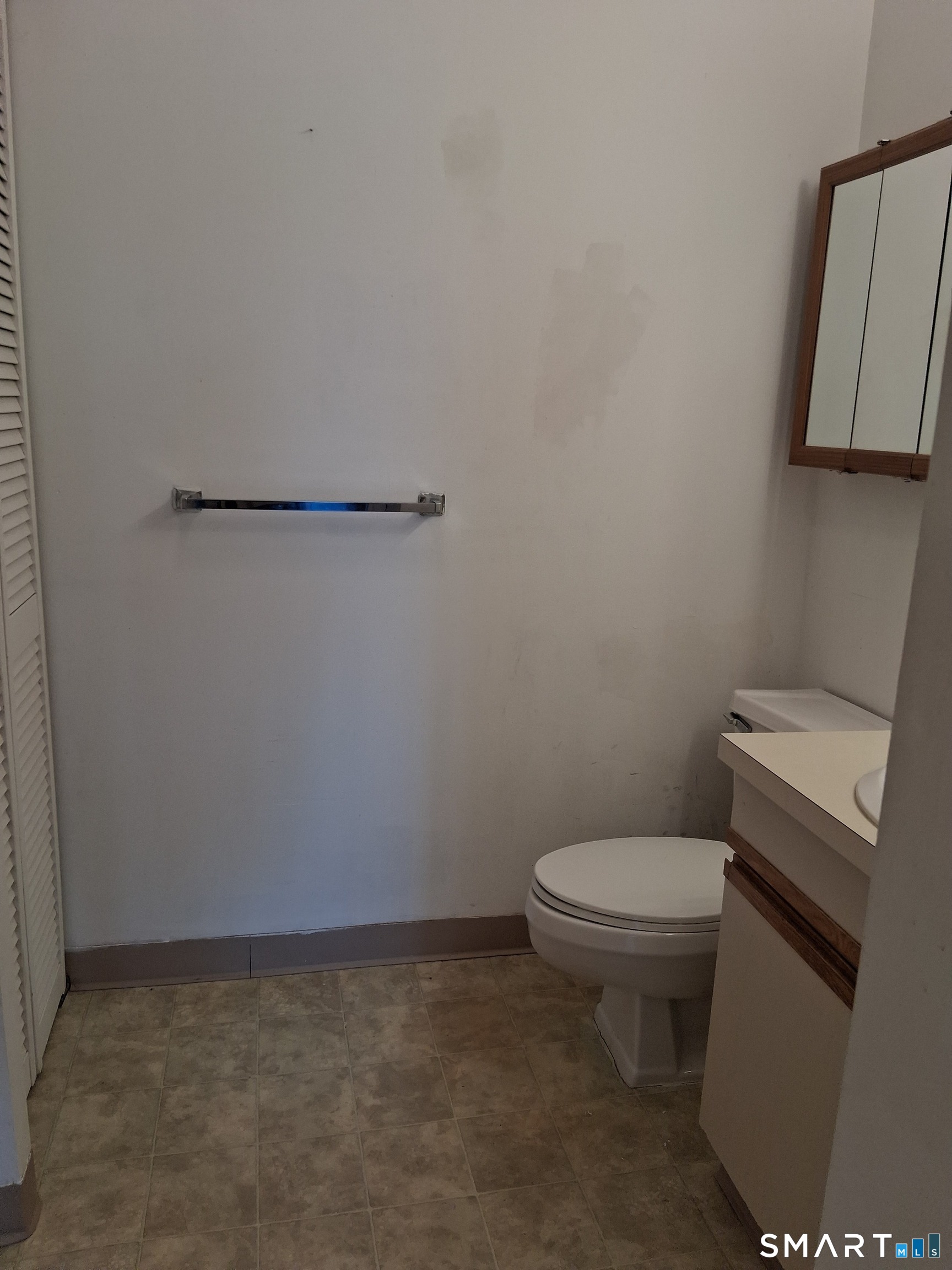 75 Washington Avenue, Unit 2402 Hamden, CT 06518 - Photo 10 of 11 a toilet sitting next to a white wall