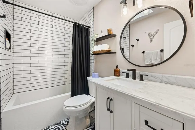 a room with furniture a flat screen tv and a window