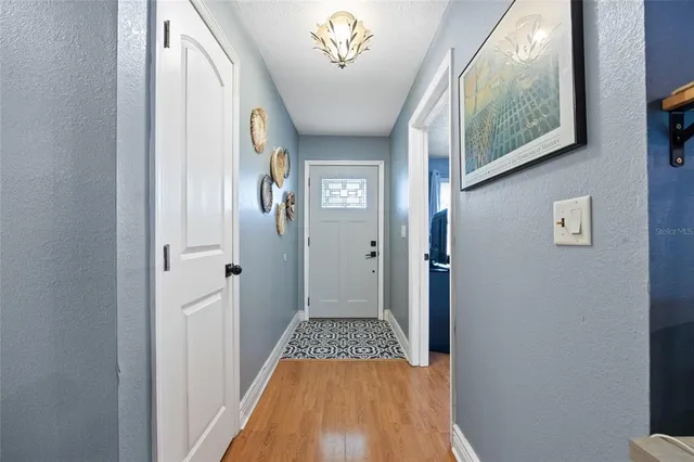 a view of a hallway view with wooden floor and staircase