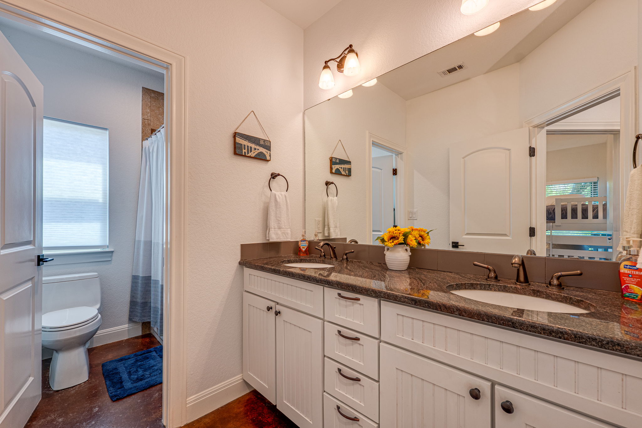 433 Venture Boulevard South Point Venture, TX 78645 - Photo 21 of 36 A full bath on the lower level keeps the secondary bedrooms easy and guest-friendly, with dual sinks and plenty of everyday function.