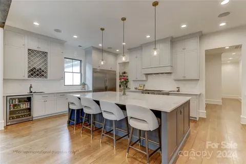 a large kitchen with a table and chairs