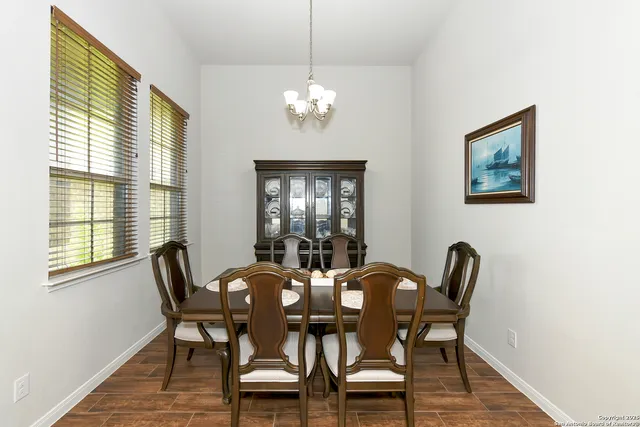 a view of a dining room with furniture and chandelier