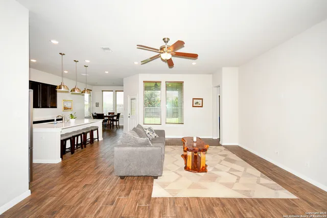 a living room with furniture and a wooden floor