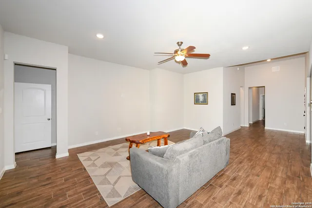 a living room with furniture and wooden floor