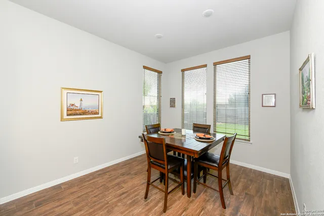 a dining room with furniture and wooden floor