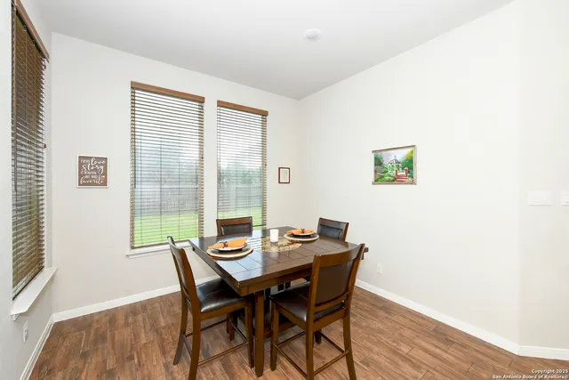 a view of a dining room with furniture wooden floor and a window