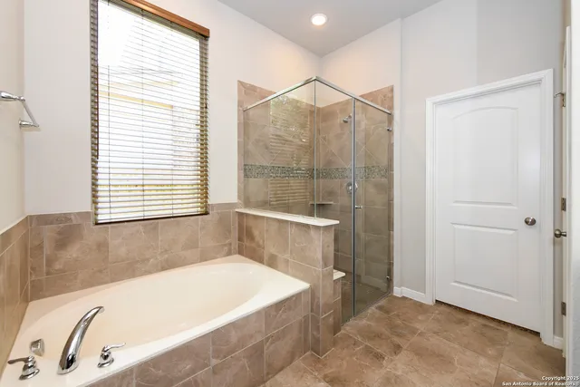 a bathroom with a bathtub and a shower