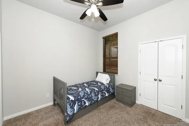 a bedroom with bed and window