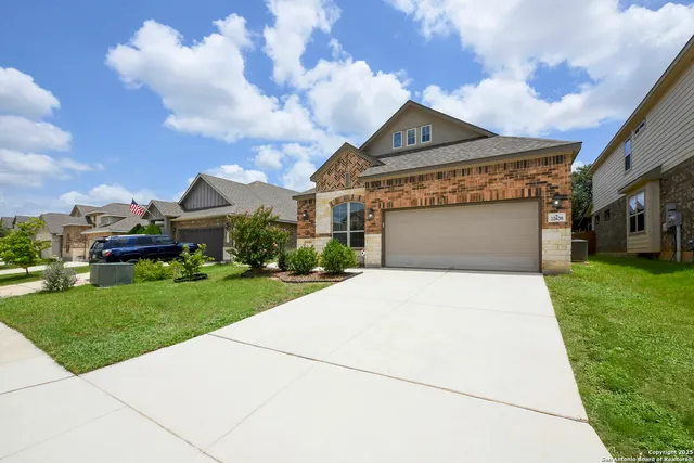 a front view of a house with a yard and garage