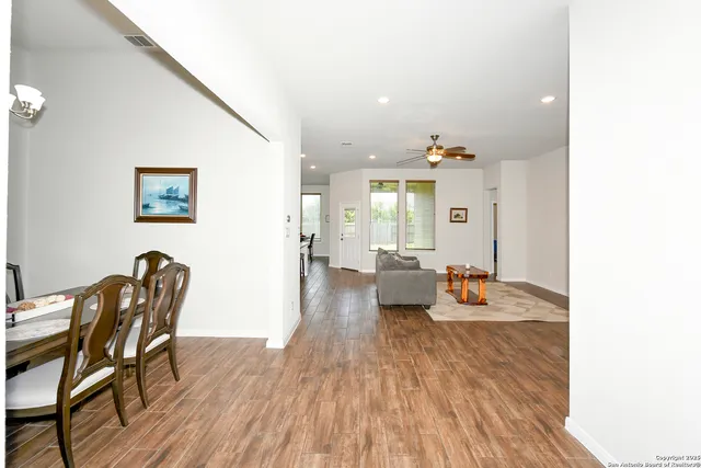 a view of a dining room with furniture and wooden floor