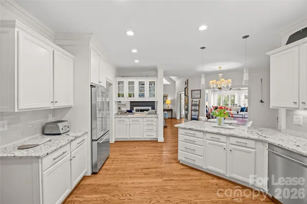 a kitchen with stainless steel appliances a refrigerator sink and cabinets