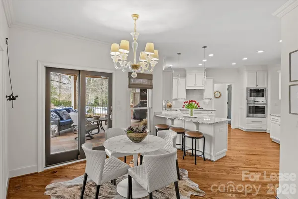 a view of a dining room with furniture wooden floor and chandelier