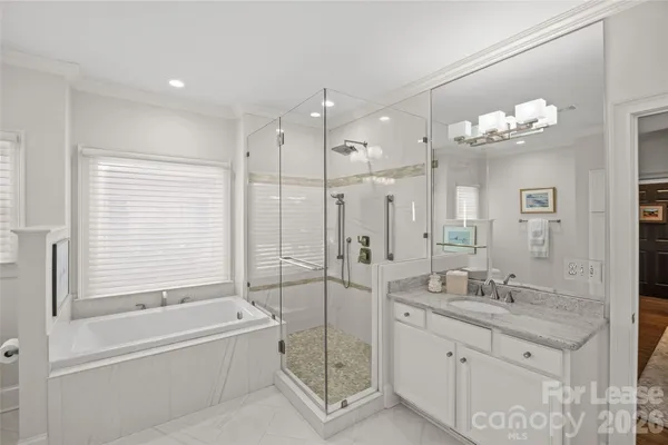 a spacious bathroom with a granite countertop sink a toilet and shower
