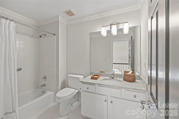 a bathroom with a bathtub shower sink vanity and toilet