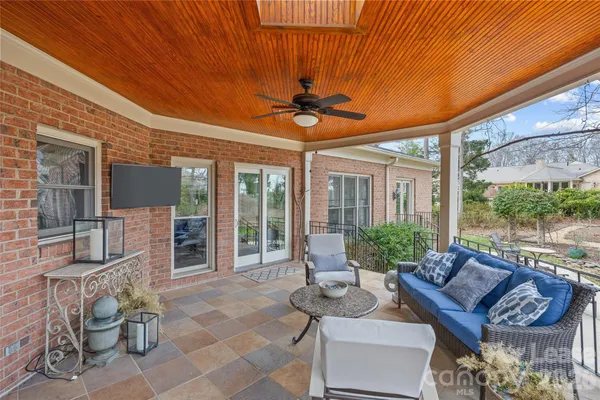 a living room with furniture and a floor to ceiling window