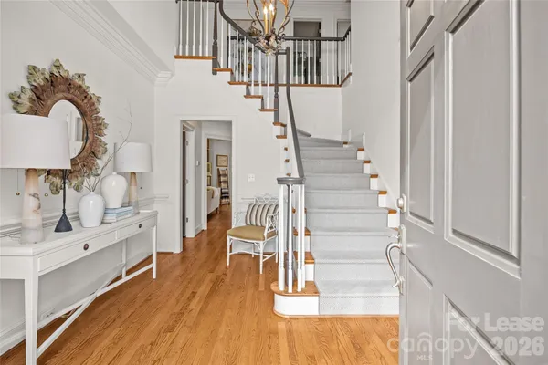 a view of entryway and hall with wooden floor