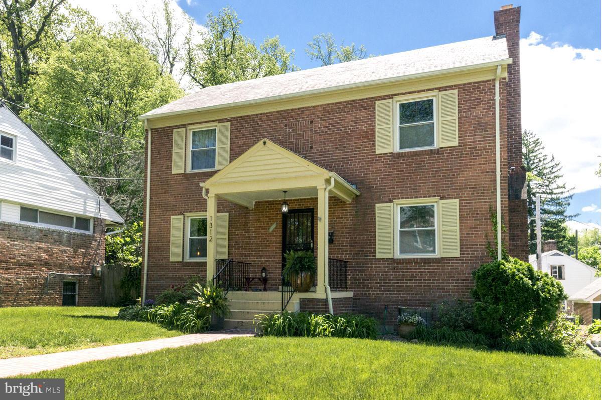 1312 Leegate Road Northwest Washington, DC 20012 - Photo 2 of 30 a front view of a house with a yard and porch