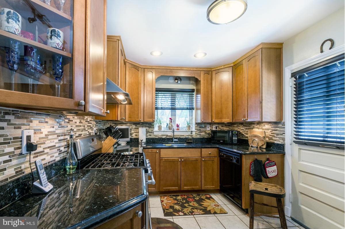 1312 Leegate Road Northwest Washington, DC 20012 - Photo 13 of 30 a kitchen with granite countertop a sink and a stove