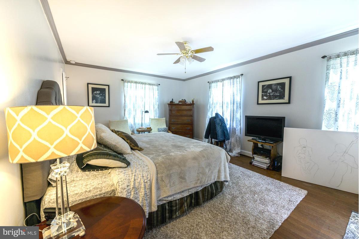 1312 Leegate Road Northwest Washington, DC 20012 - Photo 14 of 30 a bedroom with a bed and wooden floor