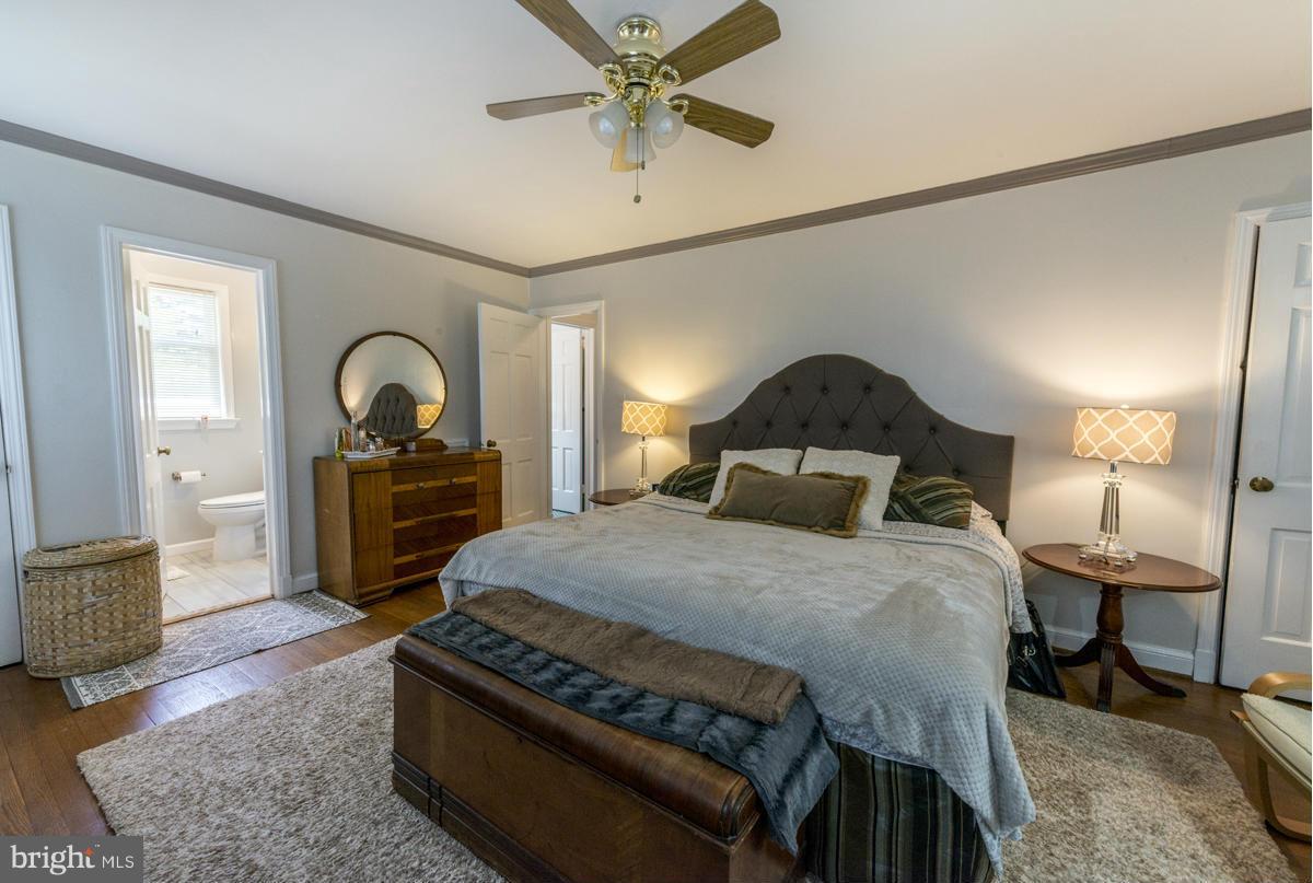 1312 Leegate Road Northwest Washington, DC 20012 - Photo 15 of 30 a bedroom with a bed and a chandelier