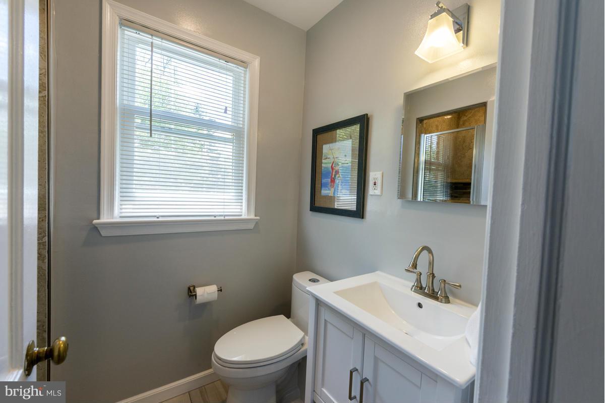 1312 Leegate Road Northwest Washington, DC 20012 - Photo 18 of 30 a bathroom with a toilet sink and mirror