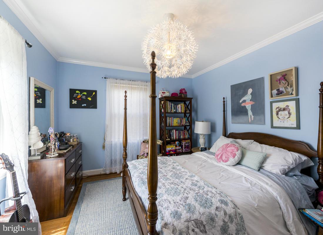 1312 Leegate Road Northwest Washington, DC 20012 - Photo 20 of 30 a bedroom with a bed and a chandelier