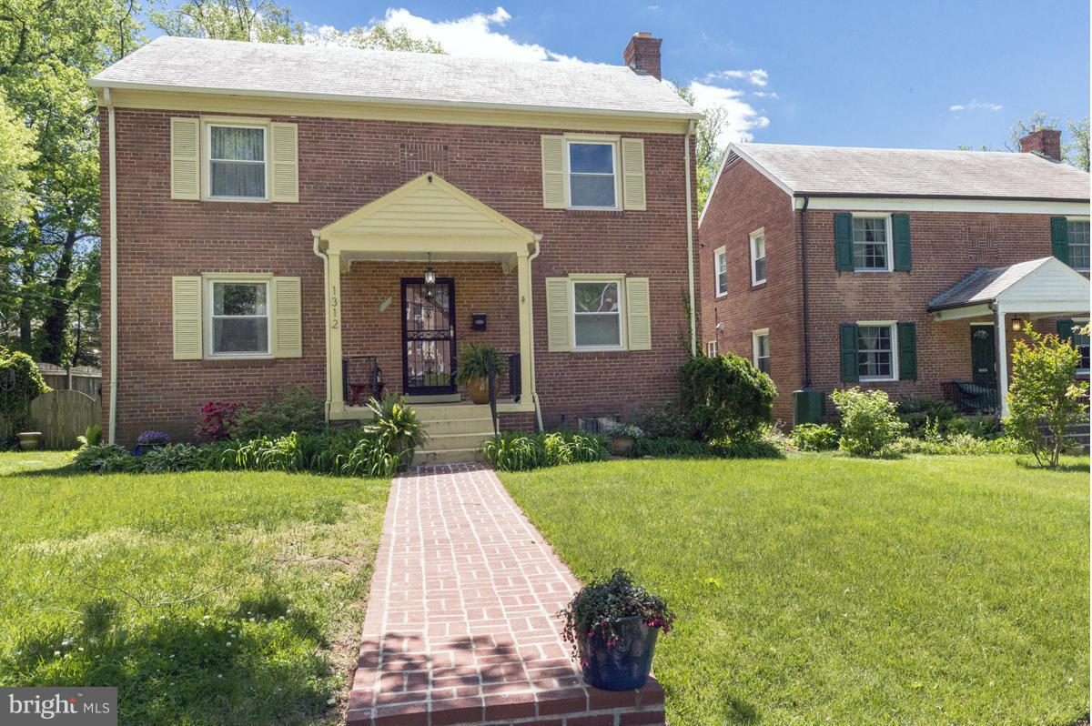 1312 Leegate Road Northwest Washington, DC 20012 - Photo 3 of 30 a front view of a house with garden