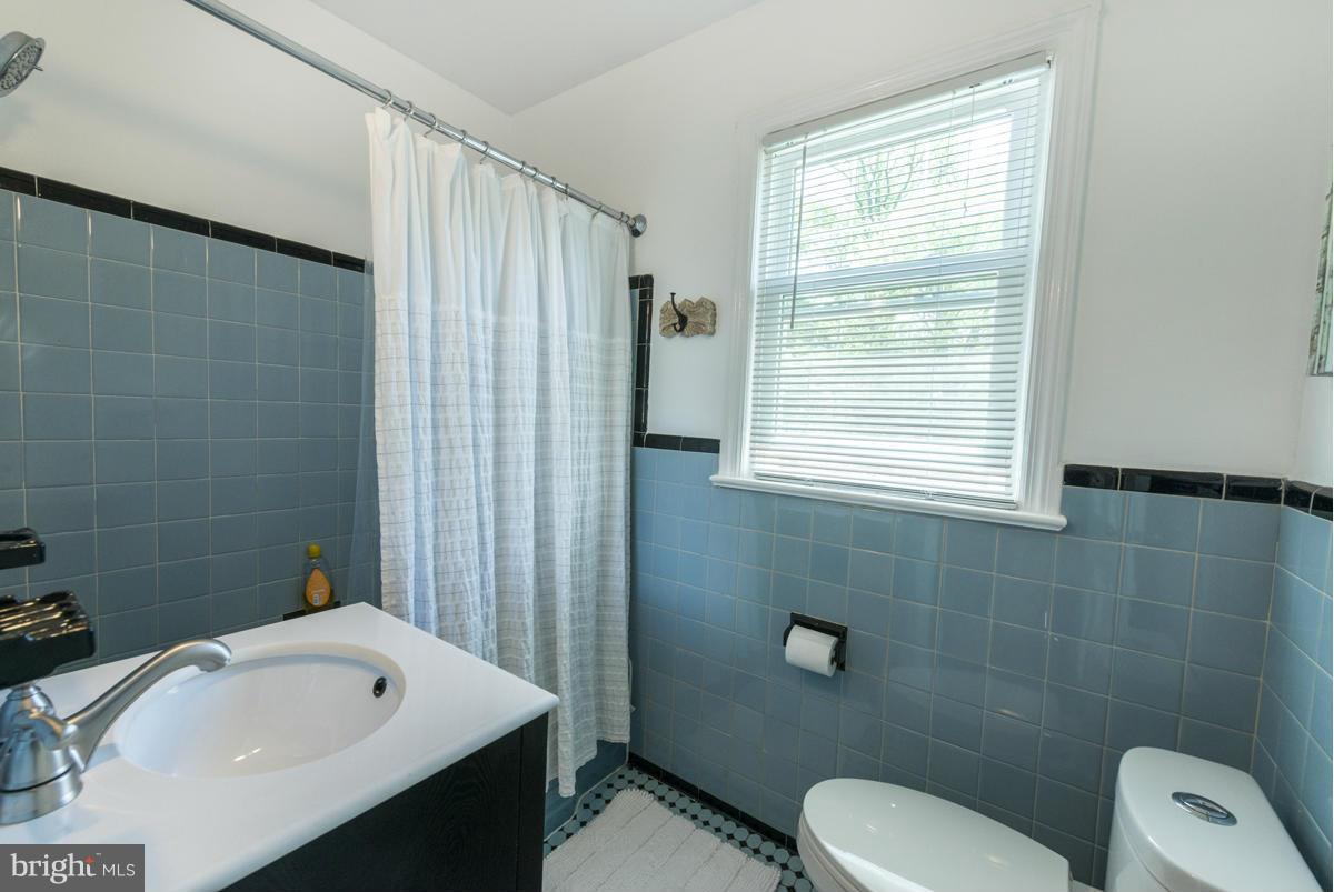 1312 Leegate Road Northwest Washington, DC 20012 - Photo 21 of 30 a bathroom with a sink a toilet and shower