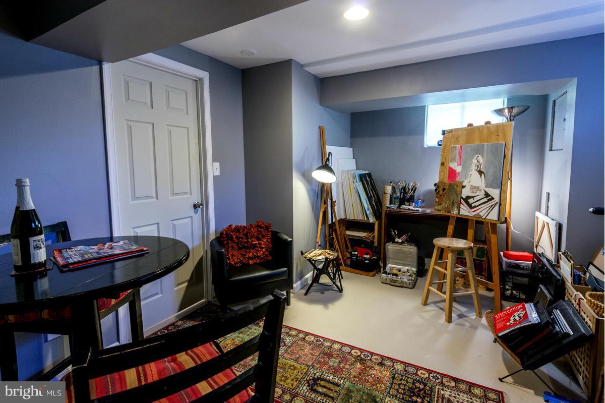 1312 Leegate Road Northwest Washington, DC 20012 - Photo 26 of 30 a living room with lots of furniture and clutter