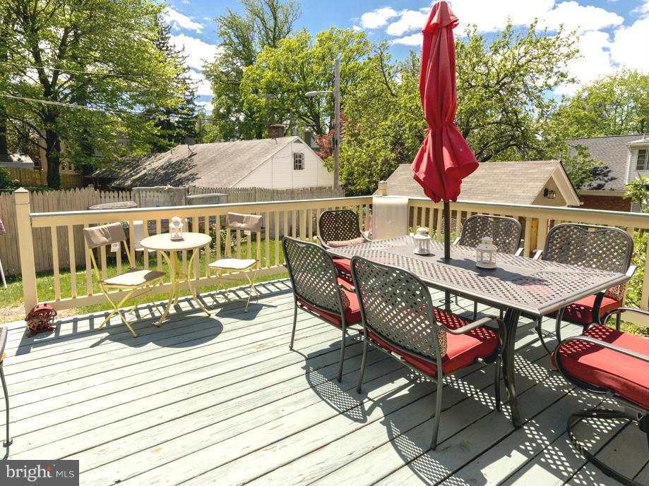 1312 Leegate Road Northwest Washington, DC 20012 - Photo 27 of 30 a view of a patio with table and chairs with wooden floor and fence