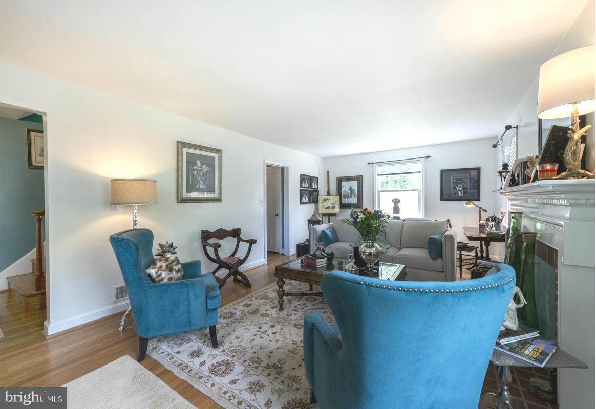 1312 Leegate Road Northwest Washington, DC 20012 - Photo 4 of 30 a living room with furniture a fireplace and a window