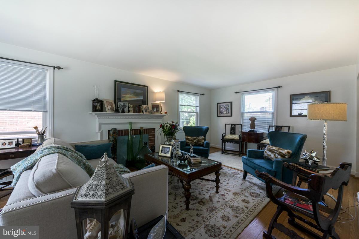 1312 Leegate Road Northwest Washington, DC 20012 - Photo 7 of 30 a living room with furniture flat screen tv and a fireplace