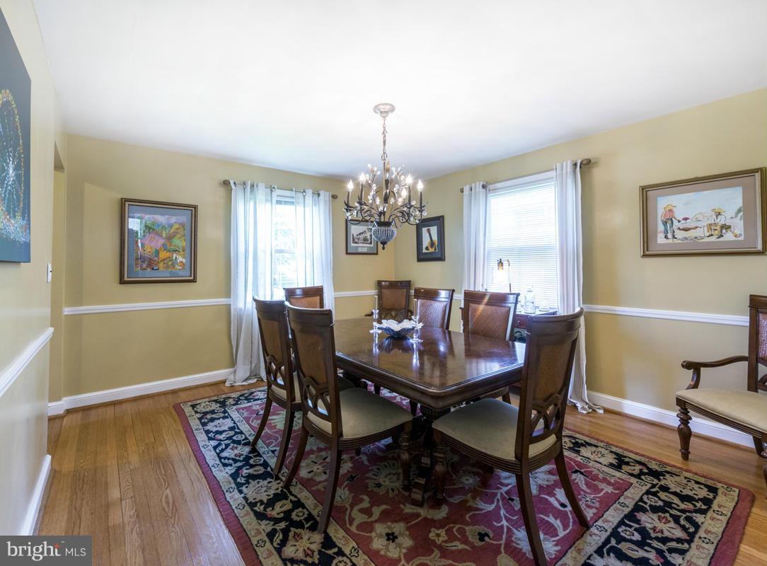 1312 Leegate Road Northwest Washington, DC 20012 - Photo 8 of 30 a view of a dining room with furniture a chandelier and wooden floor