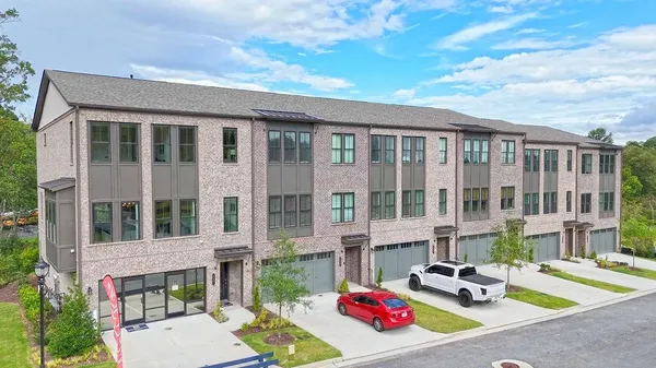 a view of a brick building next to a yard