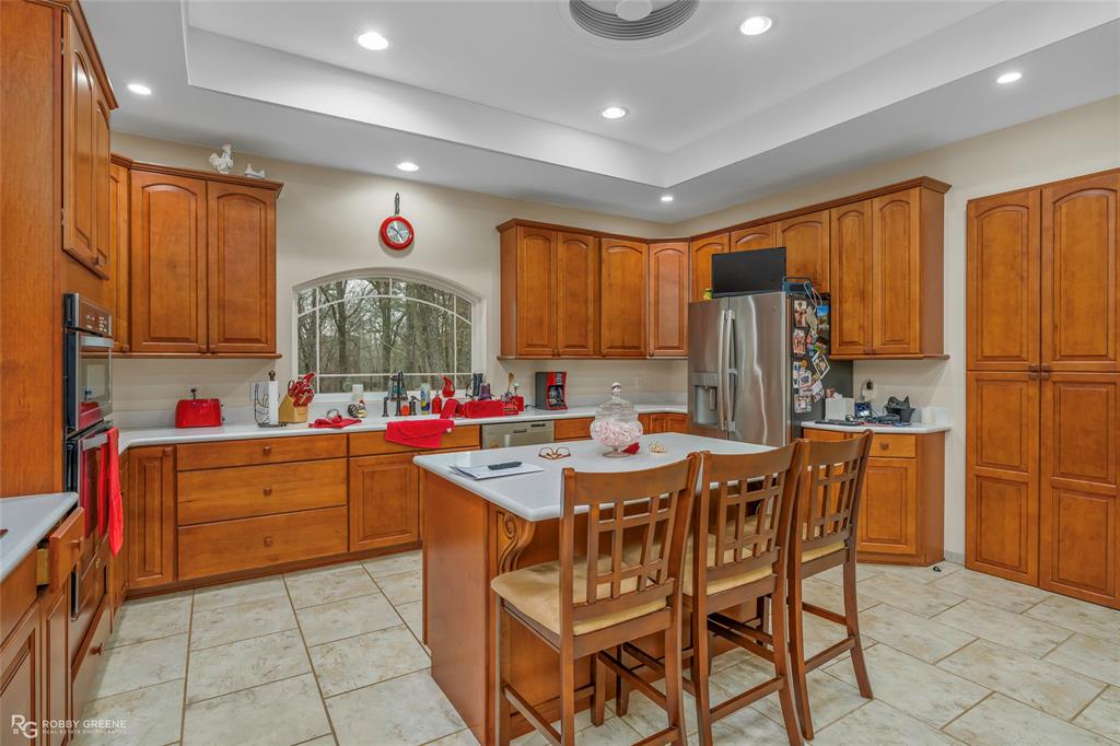 8260 Mira Myrtis Road Rodessa, LA 71069 - Photo 17 of 36 a kitchen with stainless steel appliances granite countertop a refrigerator and a stove top oven
