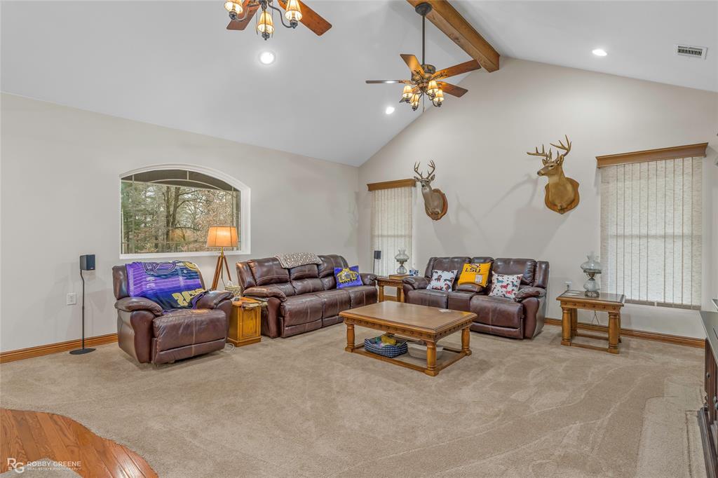 8260 Mira Myrtis Road Rodessa, LA 71069 - Photo 22 of 36 a living room with furniture and a chandelier