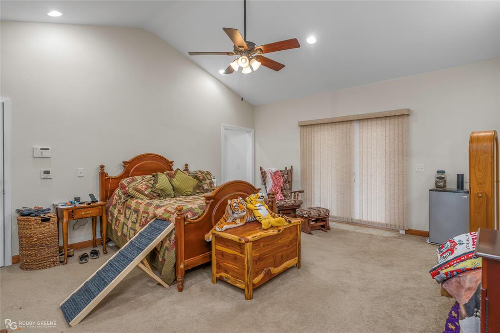 8260 Mira Myrtis Road Rodessa, LA 71069 - Photo 26 of 36 a room with gym equipment and a flat screen tv