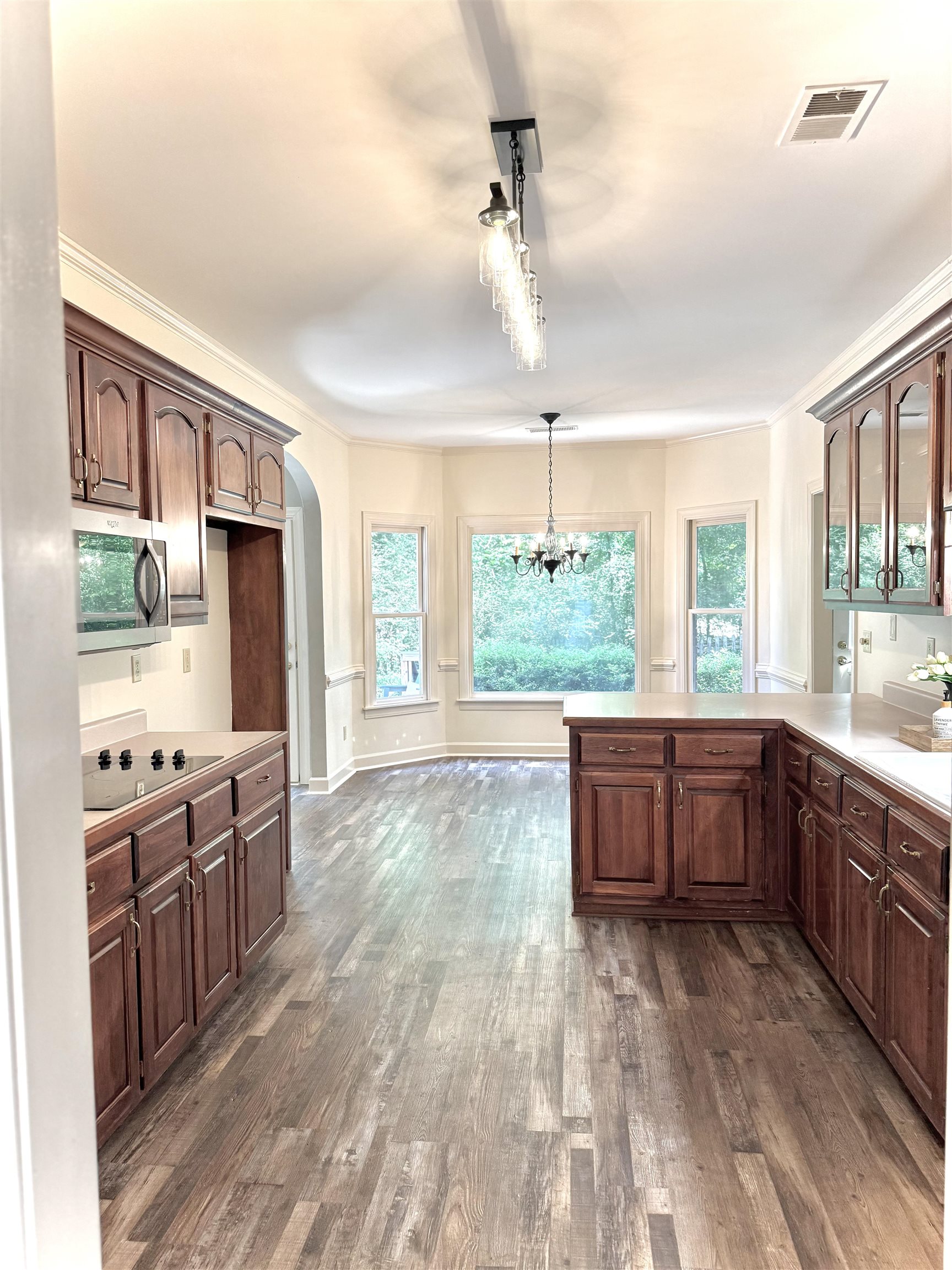 756 Crestover Drive Collierville, TN 38017 - Photo 12 of 38 a large kitchen with kitchen island granite countertop a large window and stainless steel appliances
