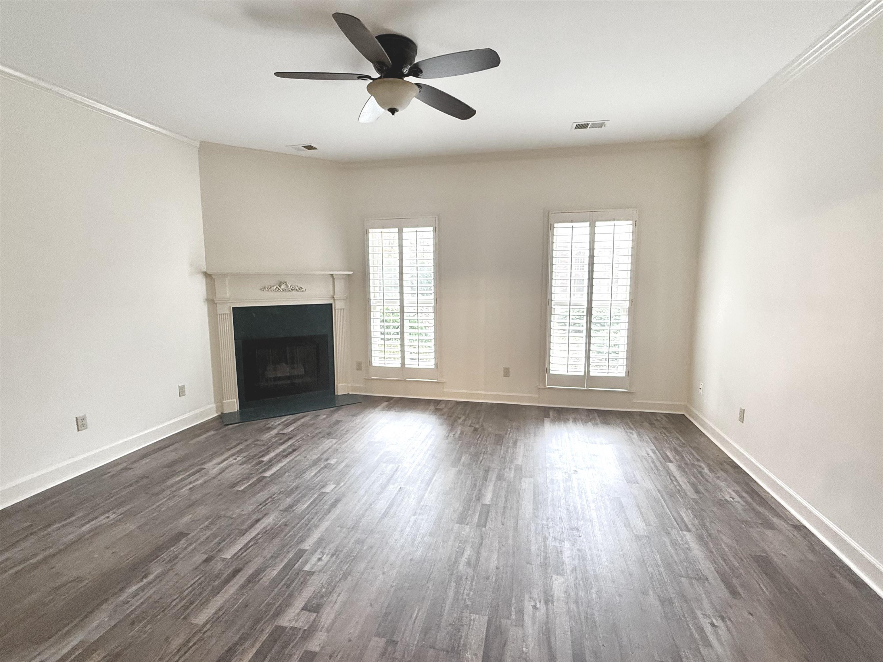 756 Crestover Drive Collierville, TN 38017 - Photo 16 of 38 an empty room with wooden floor fireplace and windows