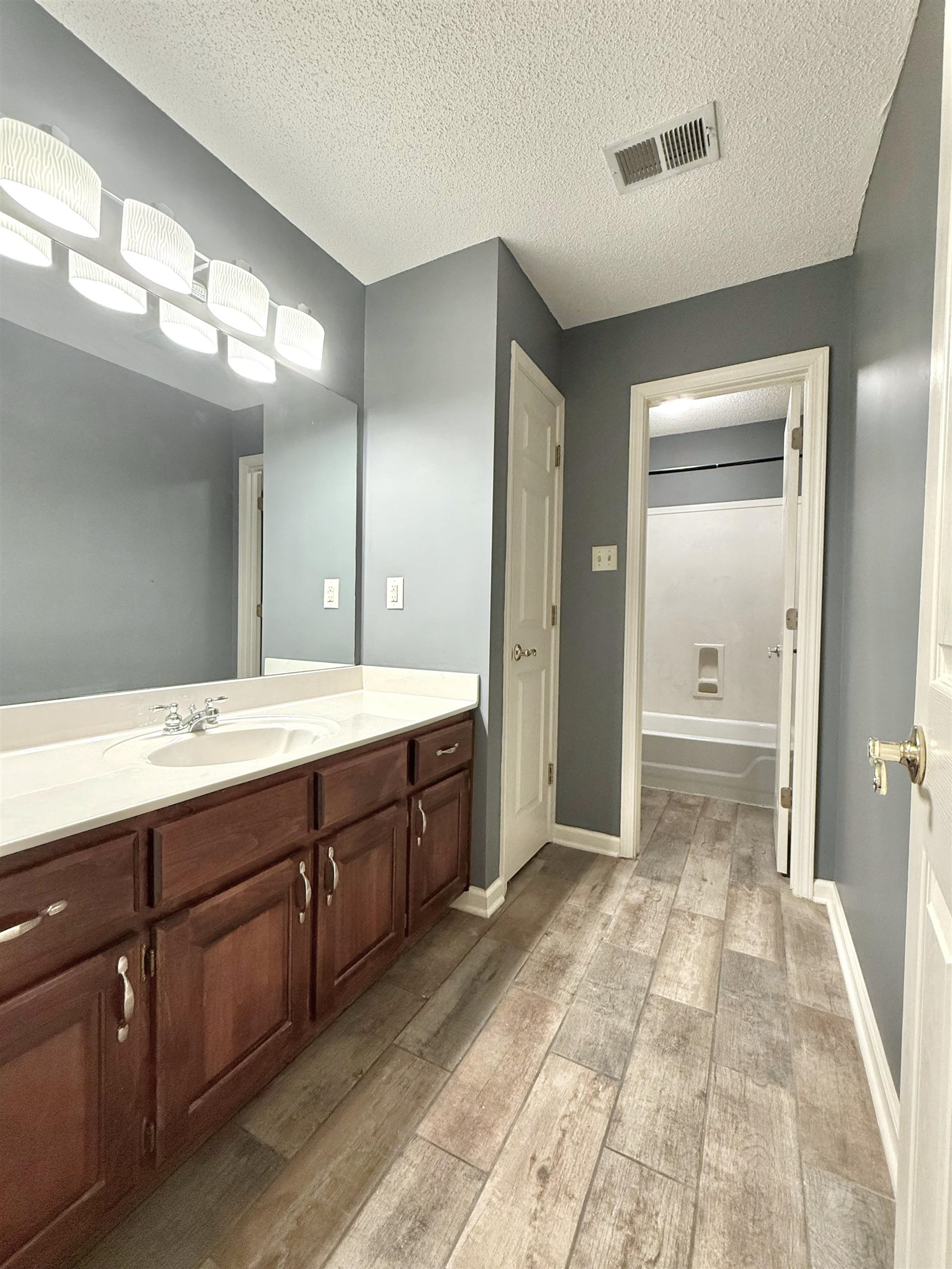 756 Crestover Drive Collierville, TN 38017 - Photo 25 of 38 a bathroom with a sink a mirror and a shower