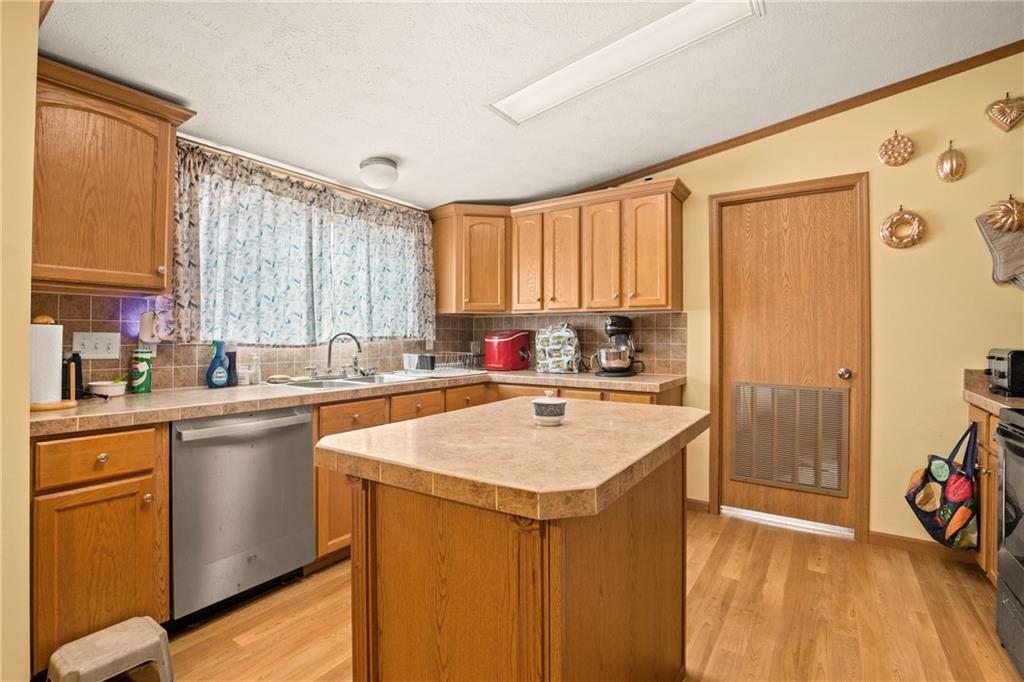 64 High View Drive Donegal, PA 15628 - Photo 8 of 9 a kitchen with a sink a stove a refrigerator and cabinets