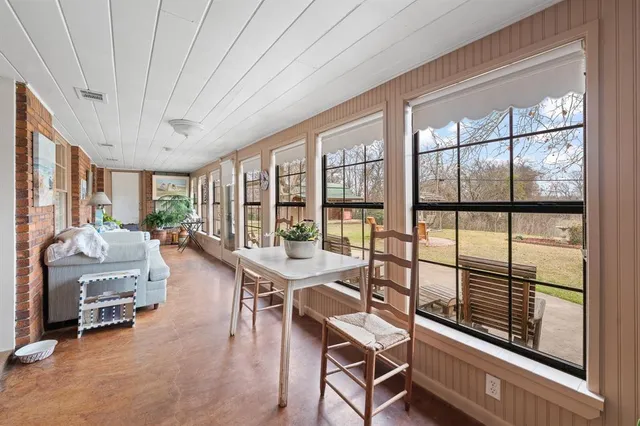 a dining room with furniture water view and wooden floor