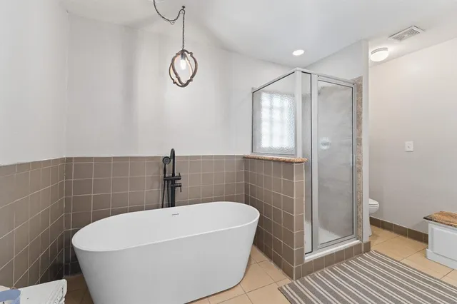 a bathroom with a white bath tub and a shower